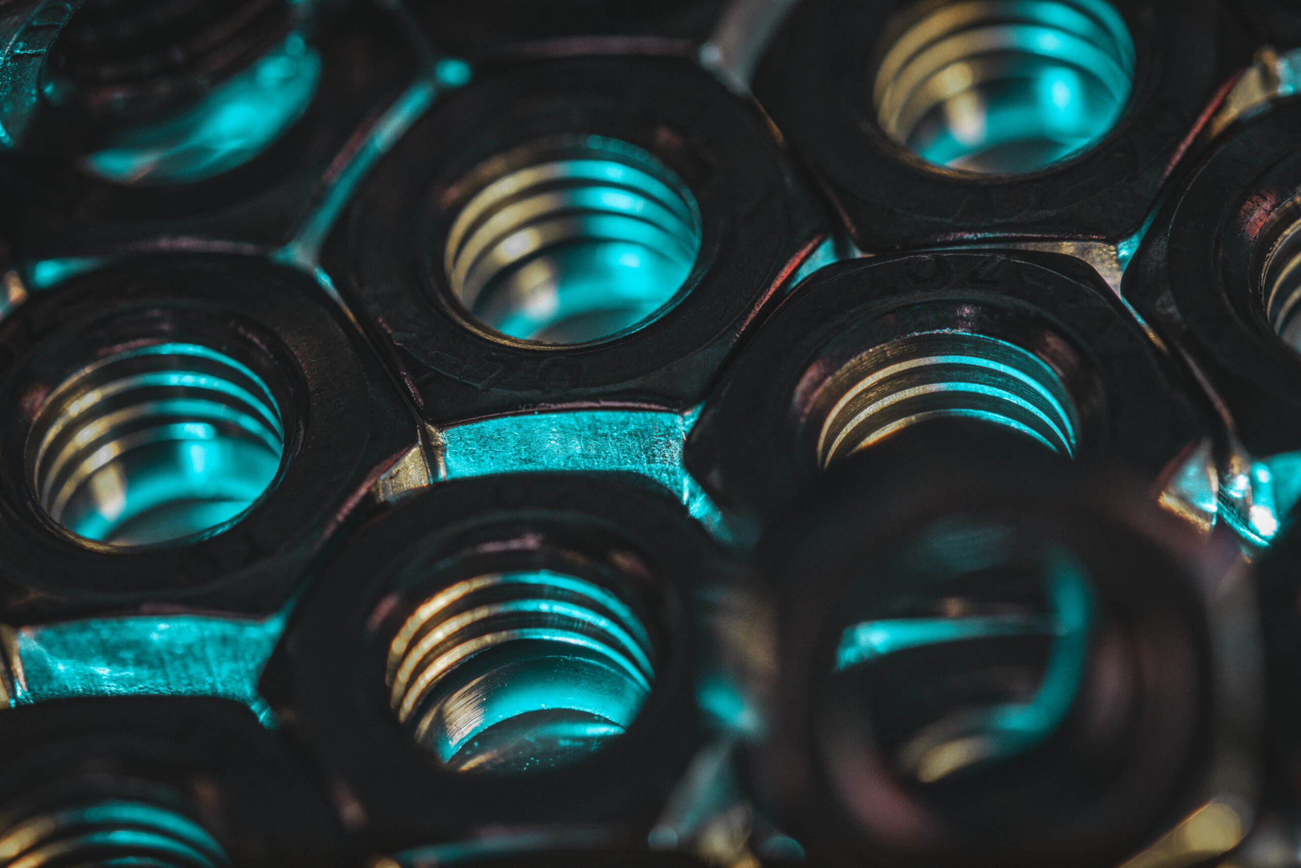 A closeup shot of screw nuts in a dark atmosphere with blue lights coming under it