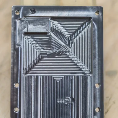 Intricately milled plate with tight-tolerance pocketing.
