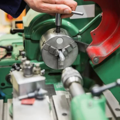 Engineering student using heavy machinery at the university